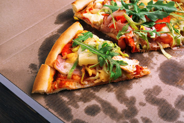 Sliced fresh pizza on cardboard background