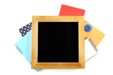 Small school blackboard with stationery isolated on white