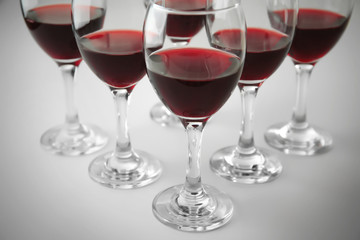 Glasses of red wine on white table closeup