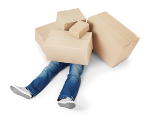 Man lying under pile of carton boxes isolated on white background