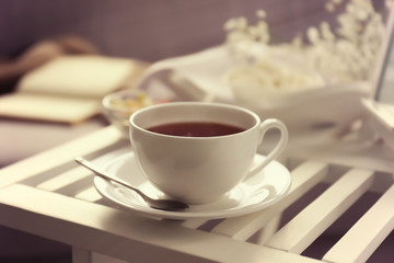Cup of tea on coffee table in the room, close up