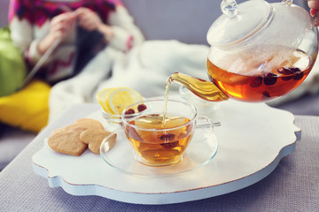 Pouring tea into cup, home atmosphere