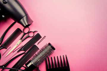 Hairdresser set with various accessories on pink background
