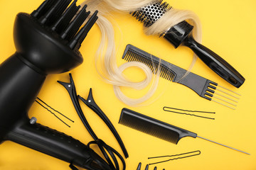 Hairdresser set with various accessories on yellow background