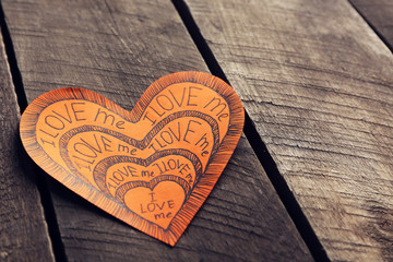 Orange Valentine with inscription on wooden background