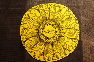 Yellow Valentine with inscription on wooden background