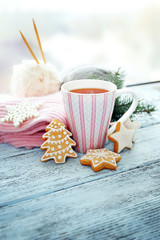 Beautiful winter composition on windowsill with cup of hot drink