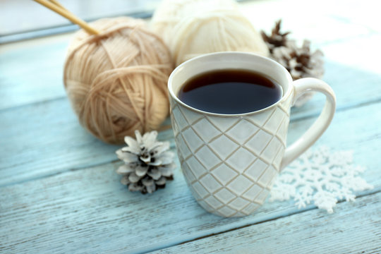 Beautiful winter composition with cup of hot drink, on wooden table