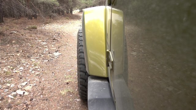 Offroad with a Jeep Wrangler JKU in the forest - Left Side Camera View  - Shot is straight out of the camera, no recompression