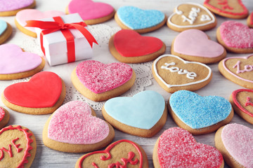 Colorful Valentine heart cookies on wooden table closeup
