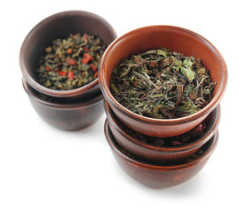 Variety of dry tea in pots isolated on white
