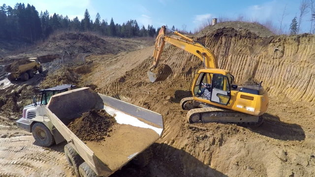 Dirt going in the beck of a truck 