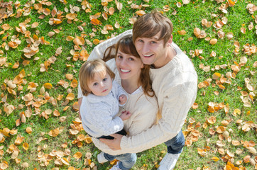 Fototapeta premium portrait of a happy family smiling in autumn a top view