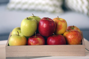 Ripe apples on tray in room