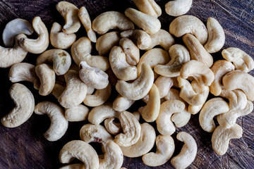 Cashew nuts on wooden cutting board background directly from above