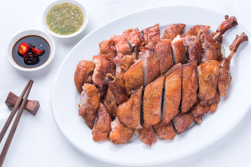 Roast duck, Chinese style on the white dish and white tablecloth