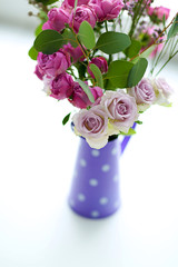 Beautiful bouquet of roses on light blurred background