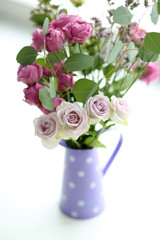 Beautiful bouquet of roses on light blurred background