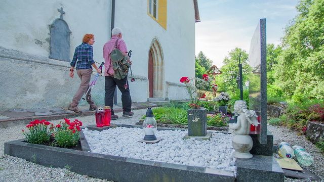 Two Older Pilgrims Walking To The Church Entrance