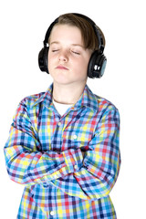 Preteen boy listening to music with headphones with eyes closed