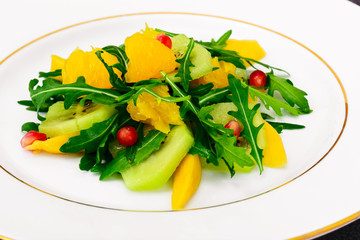 Fresh mango, arugula, kiwi, orange and pomegranate.