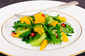 Fresh mango, arugula, kiwi, orange and pomegranate.
