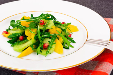 Fresh mango, arugula, kiwi, orange and pomegranate.