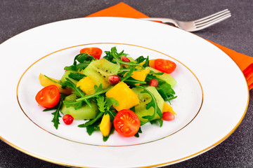 Fresh mango, arugula, kiwi, orange and pomegranate.