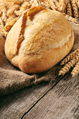 loaf of bread with ears of wheat