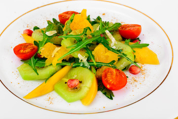 Fresh mango, arugula, kiwi, orange and pomegranate.