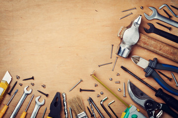 Working tools on wooden rustic background, top view