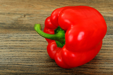 Fresh Red Bell Pepper on Wood Background.