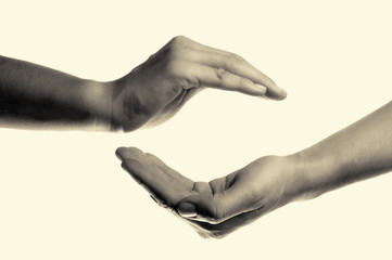 isolated toned image of two hands facing each other as a symbol of protection and insurance