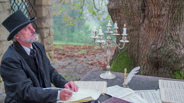 Writing a poem at a table full of notes 