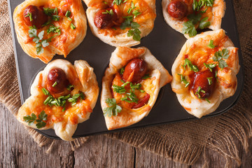 muffins with sausage, cheese close up in baking dish. horizontal top view
