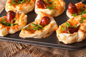 muffins with sausage, cheese close up in baking dish. horizontal
