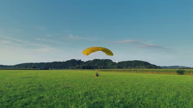 Two skydivers landing in the nature