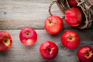 Ripe red apples on wooden background.