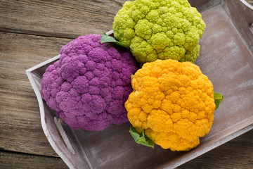 Cauliflower. Rainbow of eco on the wooden table.