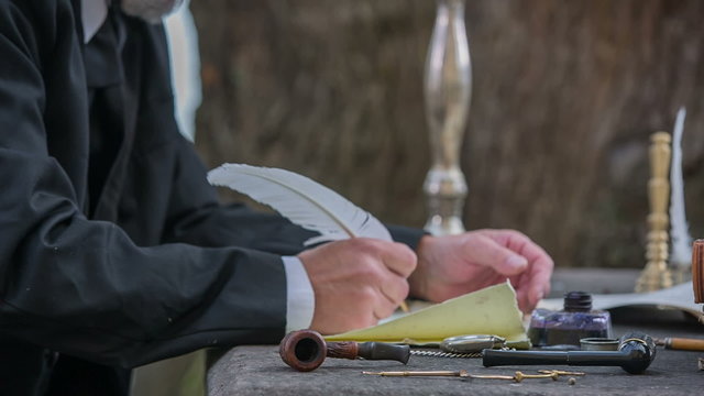 Composer from romantic times writing with feathe