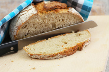 Traditional rustic rye bread on wooden board, closeup
