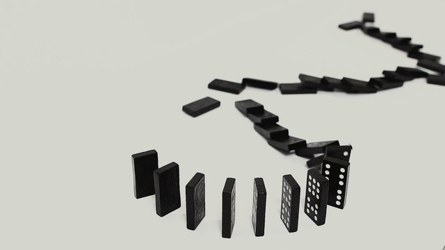 row of dominoes with one falling over