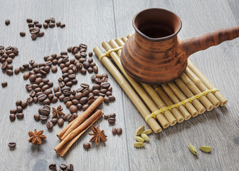 Obraz na płótnie Canvas Coffee beans and spices on a wooden table