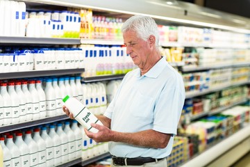 Senior man buying milk