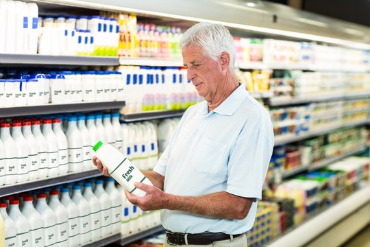 Senior Man Buying Milk