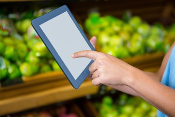 Womans hand using tablet