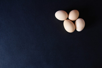 Several eggs on a black background