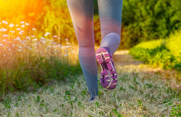 Woman running at sunset in a field