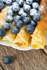 pancakes with blueberries on wooden surface