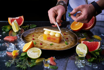Hand made citrus tart with chef's hand